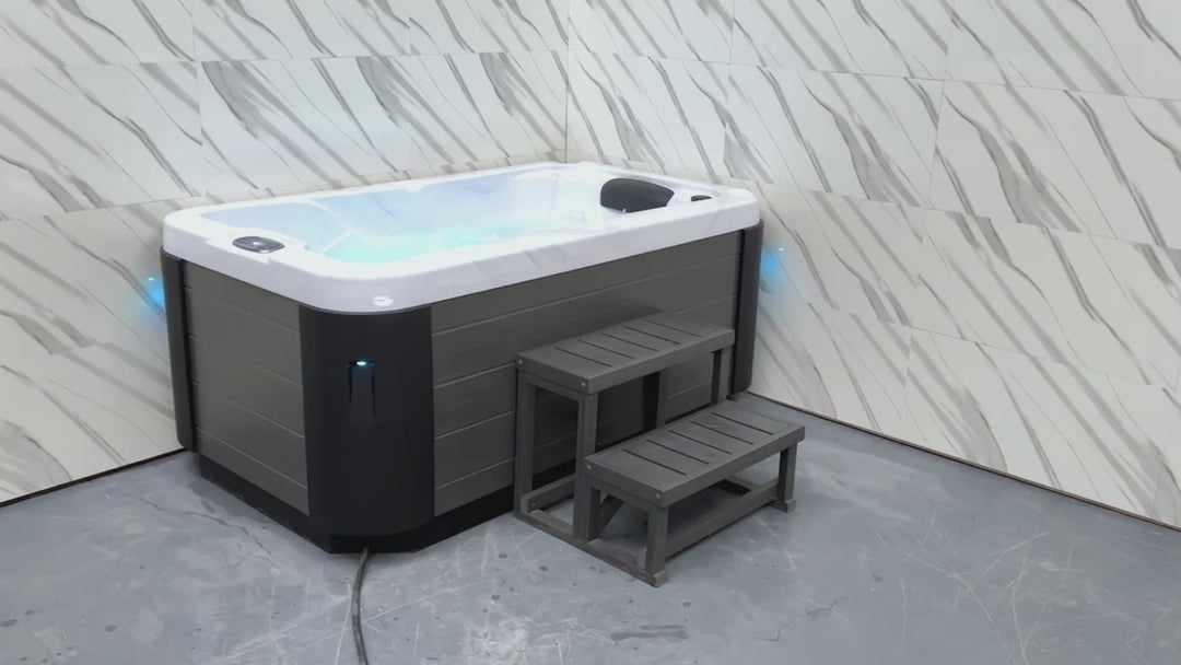 Video demonstration of compact luxury hot tub featuring white interior, jets, and LED lighting system