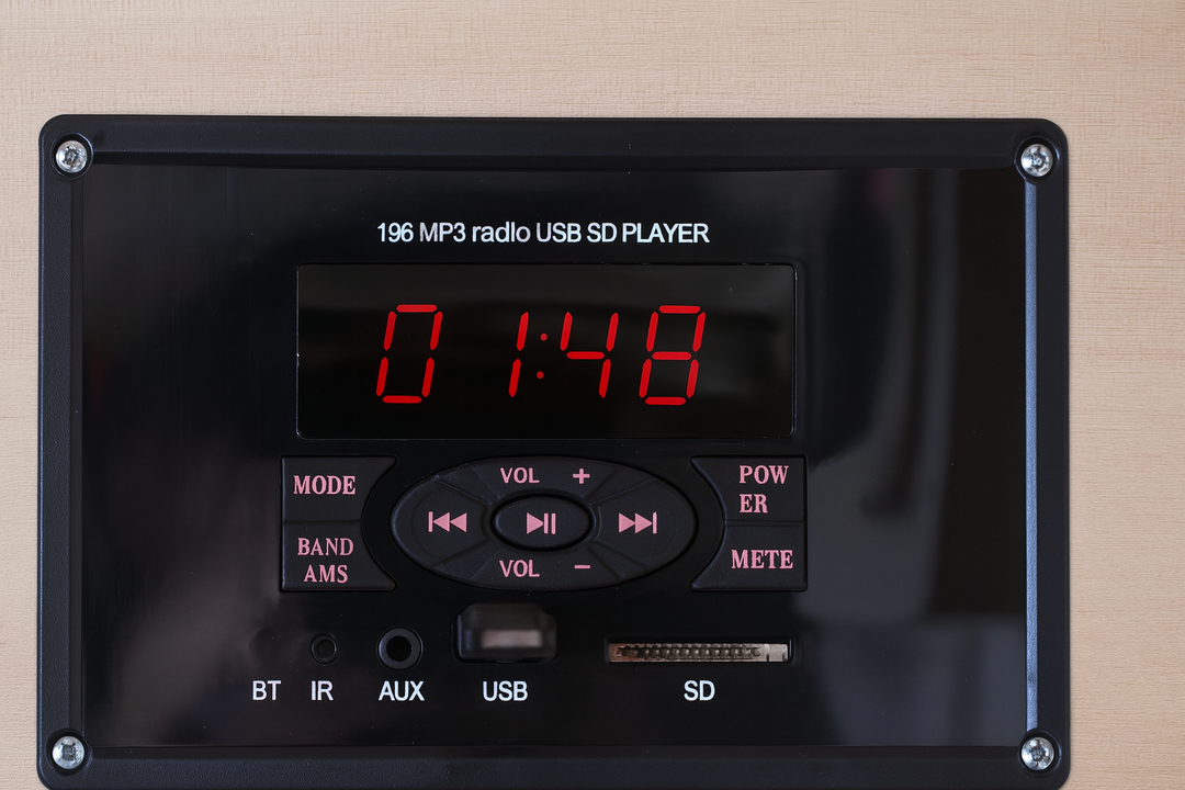 Control panel of SunRay 3-person infrared cedar sauna showing digital timer and audio input options