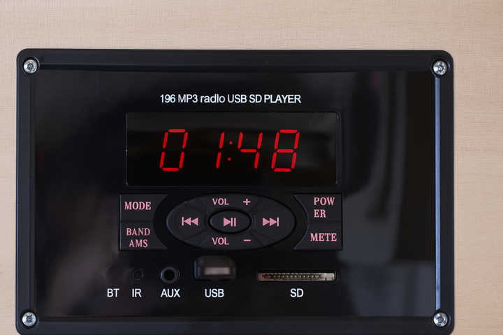 Control panel of SunRay 3-person infrared cedar sauna showing digital timer and audio input options