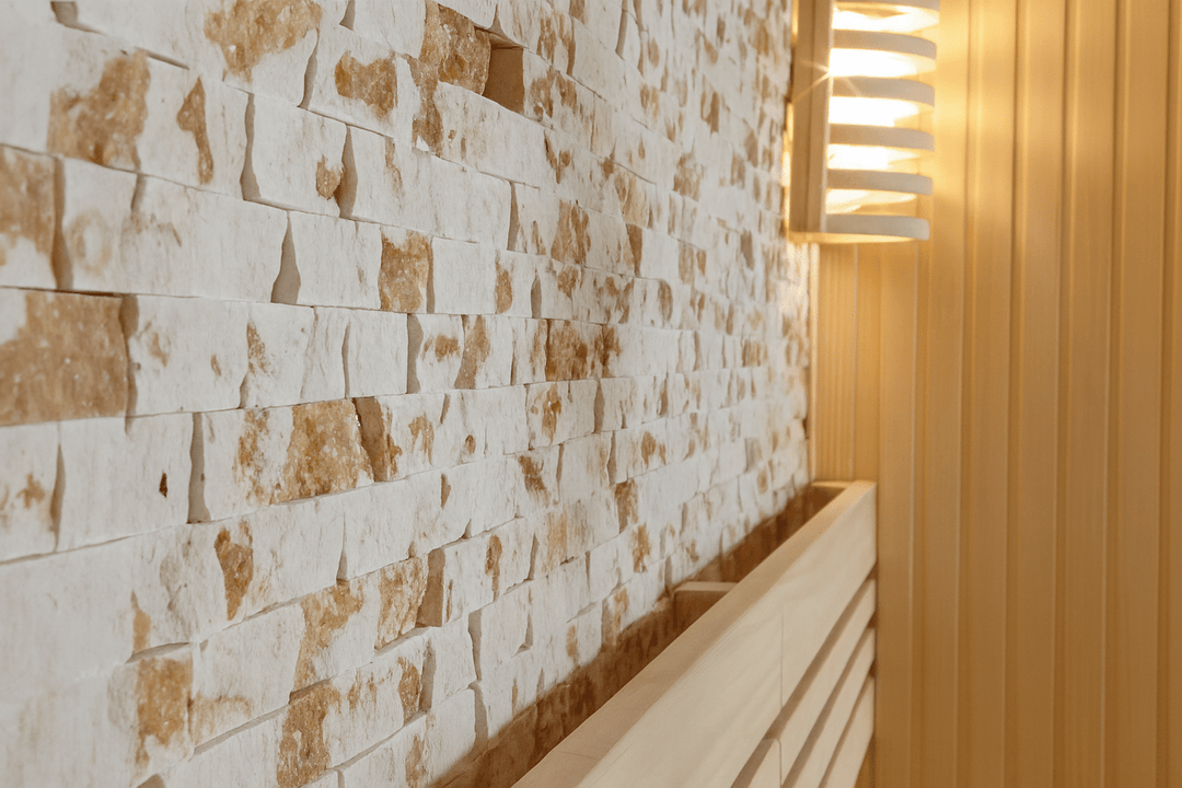 Interior of a SunRay 3-person traditional sauna featuring wooden walls and natural stone accents