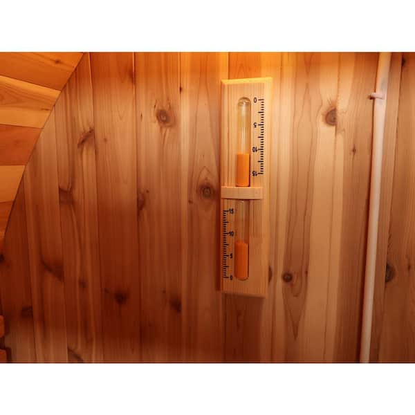 Interior view of SunRay 4-person barrel sauna featuring a hygrometer and minimalist wood design