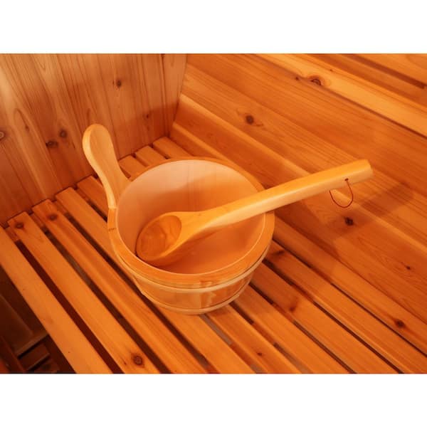 Wooden bowl and ladle inside a SunRay 4-person barrel sauna for an authentic sauna experience