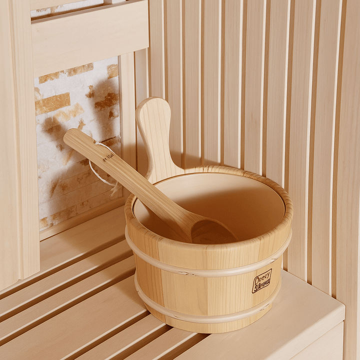 Wooden bucket and ladle inside a SunRay 4-person indoor sauna for relaxation and wellness