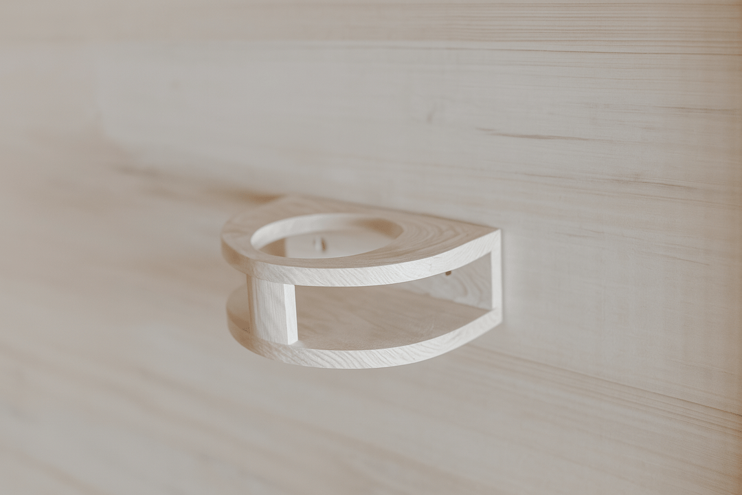 Interior detail of a SunRay 4-person infrared sauna with a wooden towel holder on the wall
