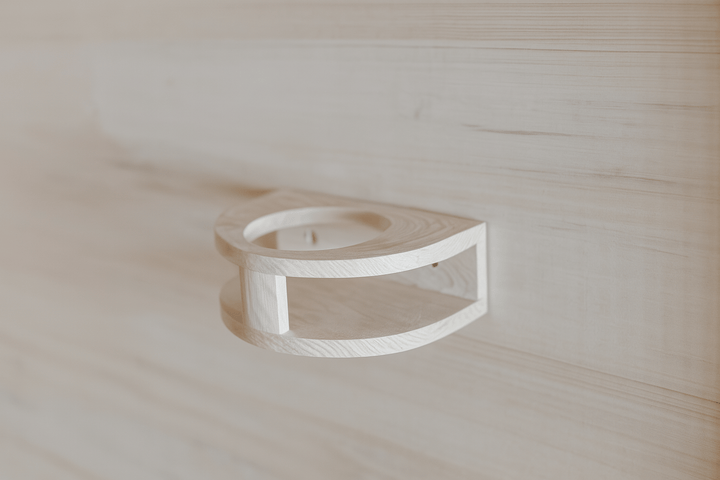 Interior detail of a SunRay 4-person infrared sauna with a wooden towel holder on the wall
