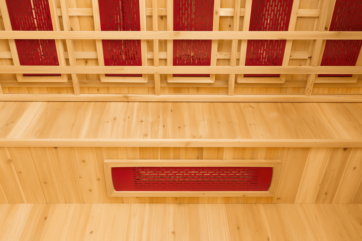 Interior view of SunRay 4 person outdoor infrared sauna with wooden benches and red heating panels