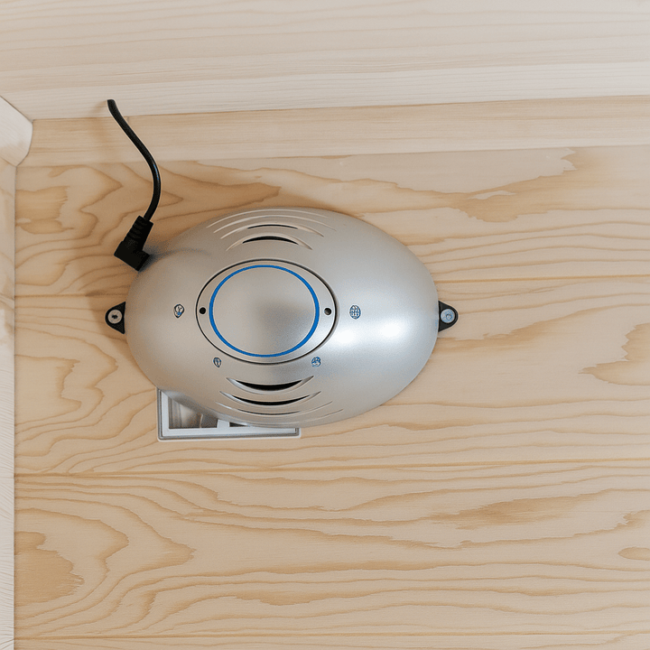 Interior view of SunRay 4 person outdoor infrared sauna with silver heating unit and wooden paneling