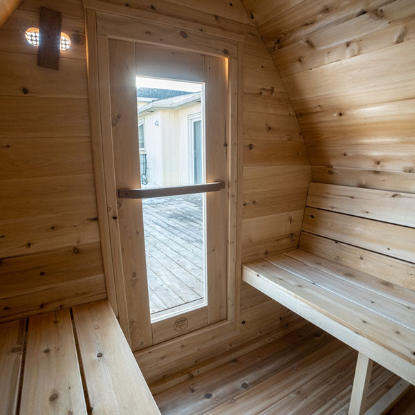 Interior of Leisurecraft traditional sauna with wooden benches and glass door for backyard saunas for homes