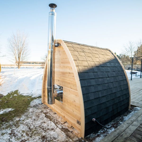Leisurecraft traditional wooden sauna with chimney designed as backyard saunas for homes in snowy outdoor setting