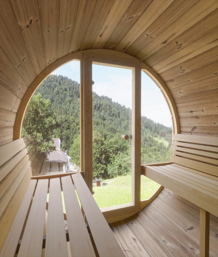 Interior view of SaunaLife barrel sauna with glass front showing wooden benches and scenic outdoor landscape