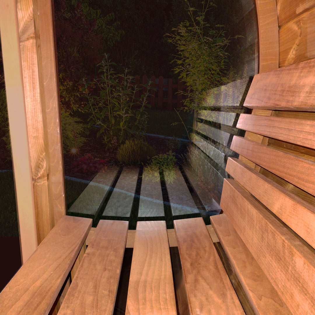 Interior view of a SaunaLife barrel sauna with glass front showcasing wooden benches and serene outdoor scenery