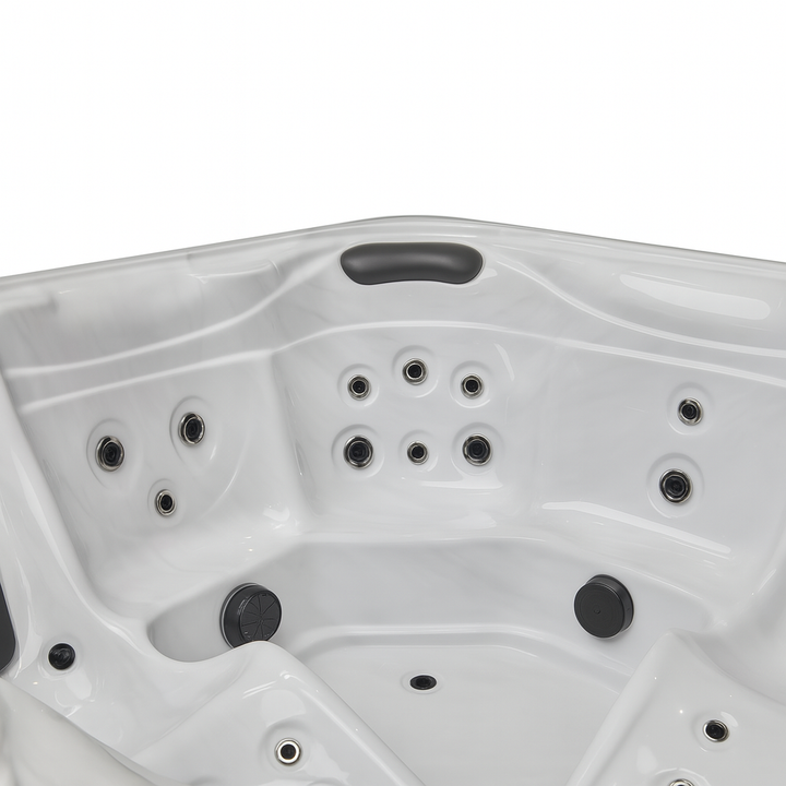 White Luxury Spa Estes Studio Series spa hot tub interior with multiple massage jets and headrest