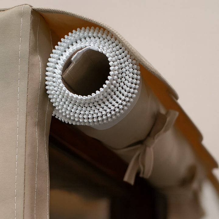 Close-up of rolled Finnmark FD-2 sauna cover with beige fabric and white mesh detailing