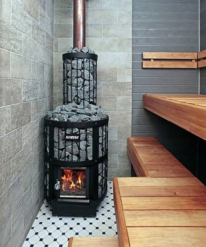 Harvia 16kW sauna heater for home with stacked sauna stones and visible fire in wooden sauna room