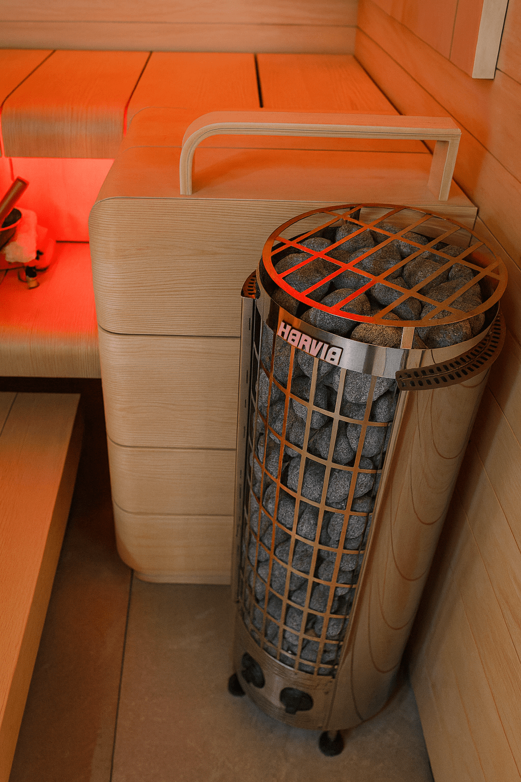 Harvia Cilindro PC90 sauna heater with decorative stones in a wooden sauna interior