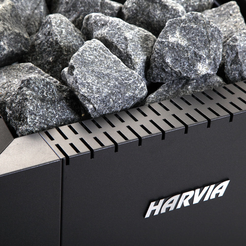 Close up of Harvia Linear 16 wood-burning sauna stove with stacked sauna stones and vents