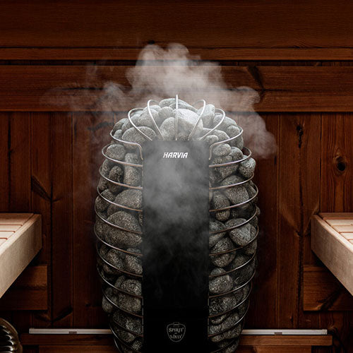 Harvia SP60E electric sauna heater with sauna stones producing steam in a wooden sauna interior