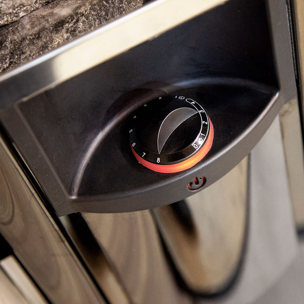 Harvia The Wall sauna heater close up of black control knob with numbered dial on stainless steel body