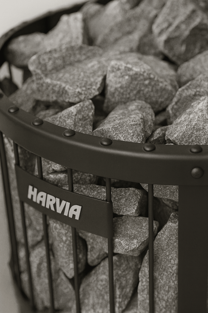 Harvia Legend 240GF sauna heater with a sleek metal design and heated natural stones for authentic sauna experience