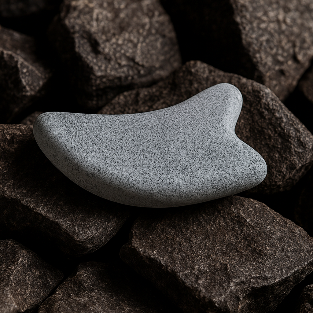 Hukka guasha massage stone for sauna on dark sauna rocks smooth ergonomic grey massage accessory