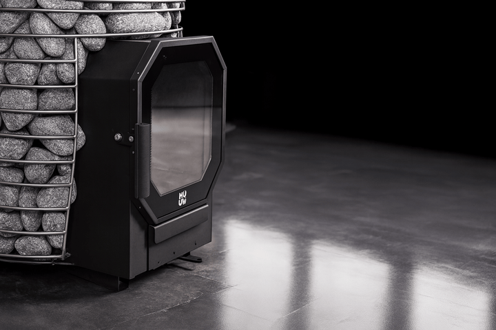 HUUM home sauna heater package featuring a sleek black design with a glass door and stone storage