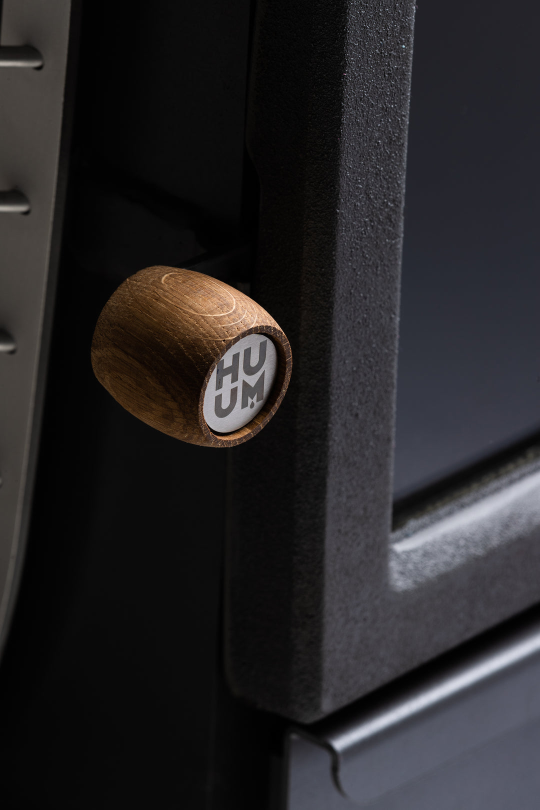 HUUM wood burning sauna stove close-up of wooden handle and cast iron door