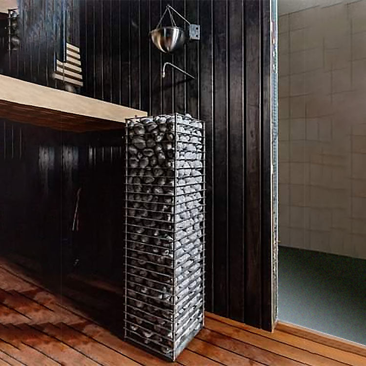HUUM CLIFF 11kW electric sauna heater with stacked stones in a modern wooden sauna room