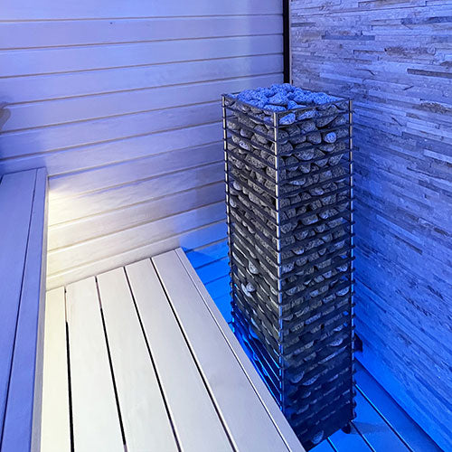 HUUM CLIFF 9kW electric sauna heater with stacked stones inside a modern sauna room