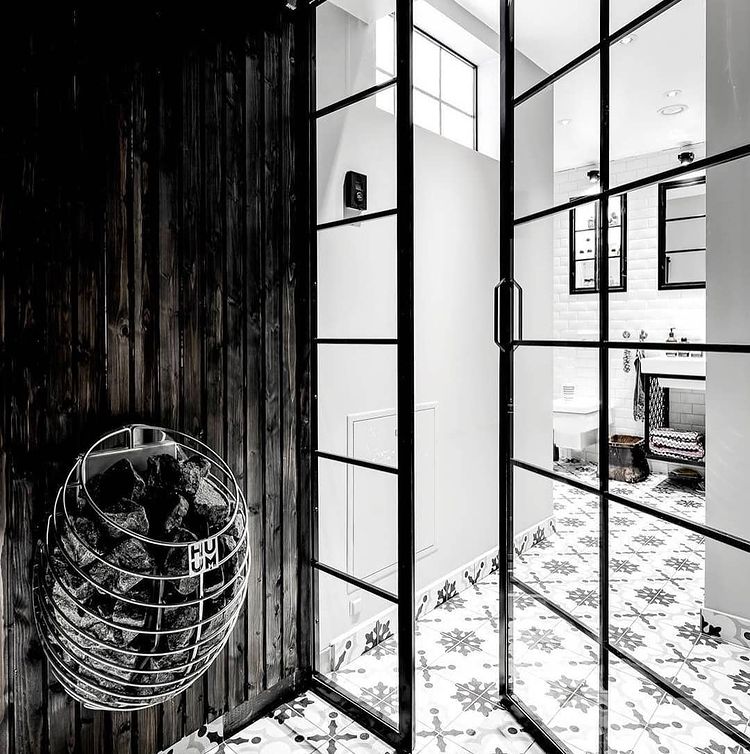 HUUM DROP 7.5kW sauna heater mounted on dark wooden wall inside modern sauna room