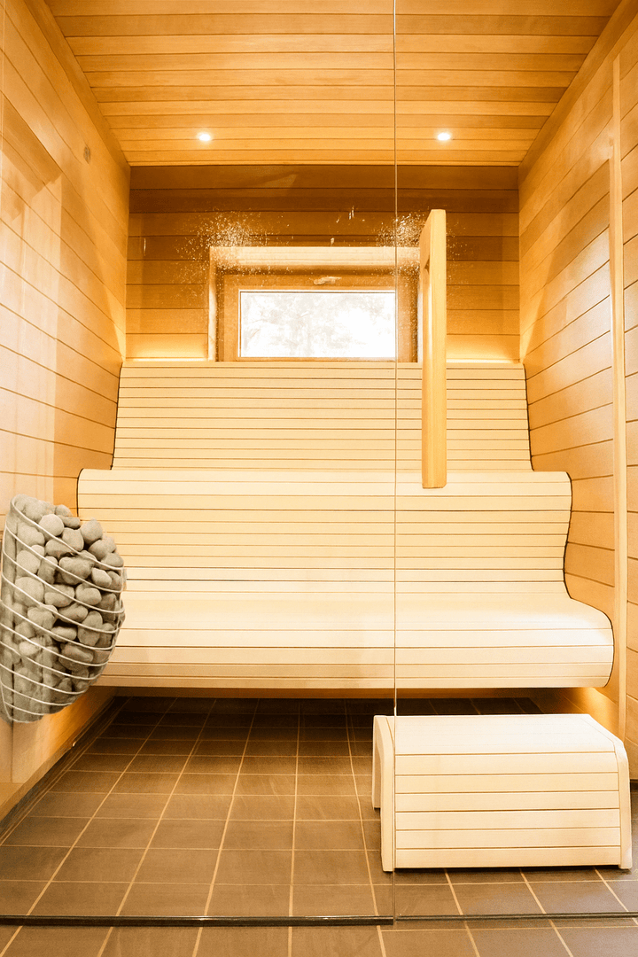 HUUM DROP sauna heater installed in a modern wooden sauna with sleek benches and lighting