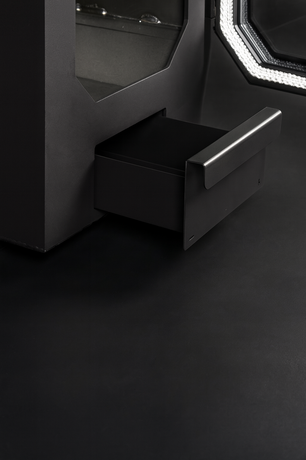Close-up of HUUM HIVE Flow Series sauna heater black drawer handle and sleek modern design