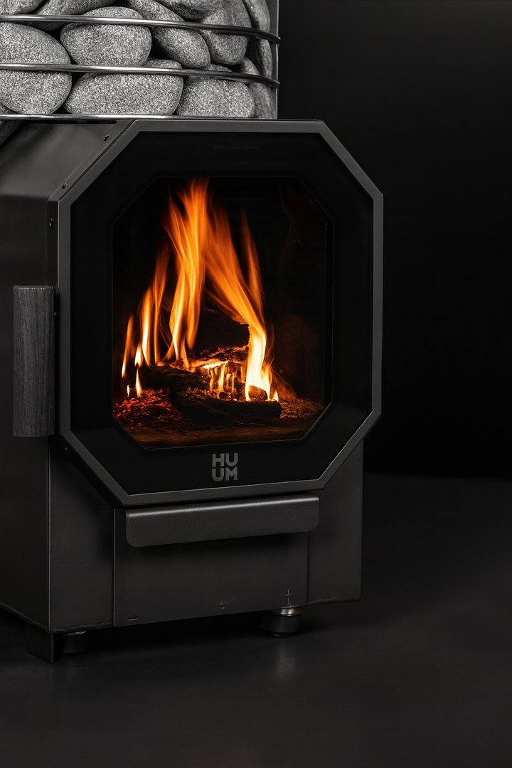 HUUM sauna heater with visible flames and sauna rocks in home sauna heater package