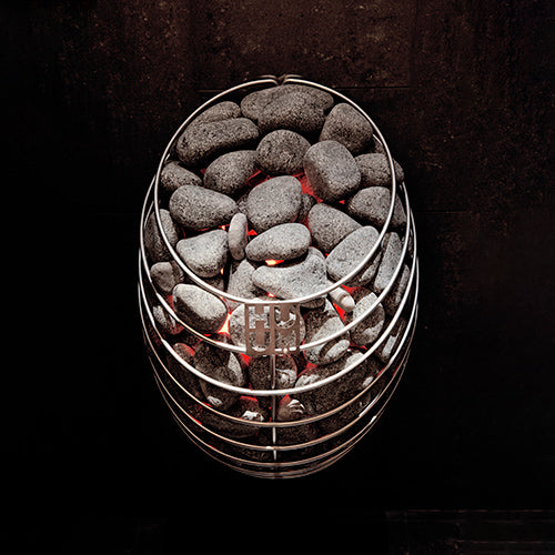 Wall mounted HUUM DROP 4.5kW sauna heater. Stainless steel cage filled with glowing sauna stones