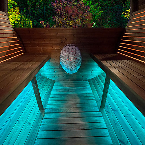 HUUM DROP 7.5kW sauna heater stone clad egg unit in wooden sauna with teal underbench LED lighting