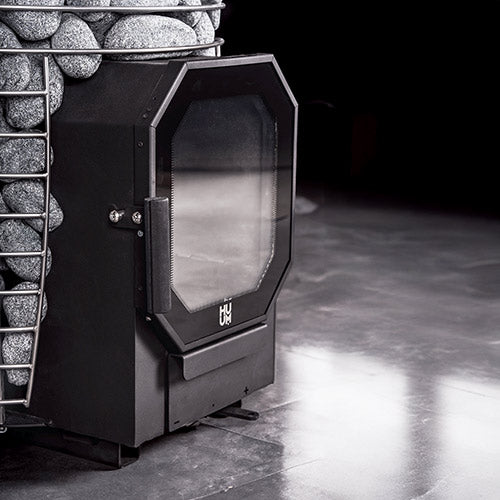 HUUM HIVE Heat Flow Mini 8.5kW black sauna heater closeup with stone basket and glass door