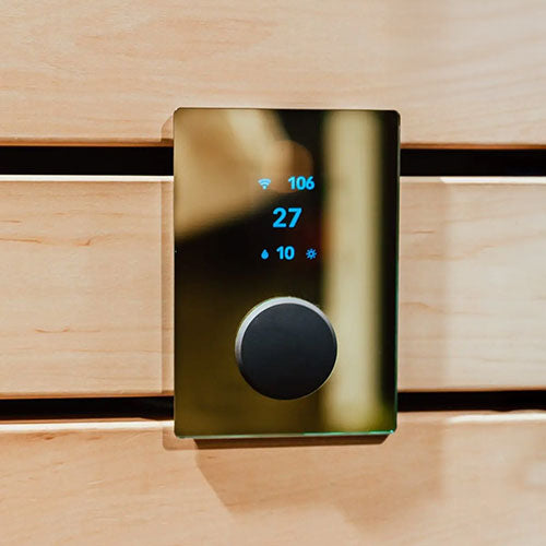 HUUM UKU Gold sauna control with digital display and black knob mounted on wooden wall