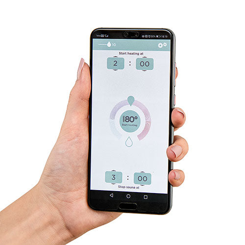HUUM UKU Wi-Fi sauna controller app displayed on smartphone held in hand with heating settings