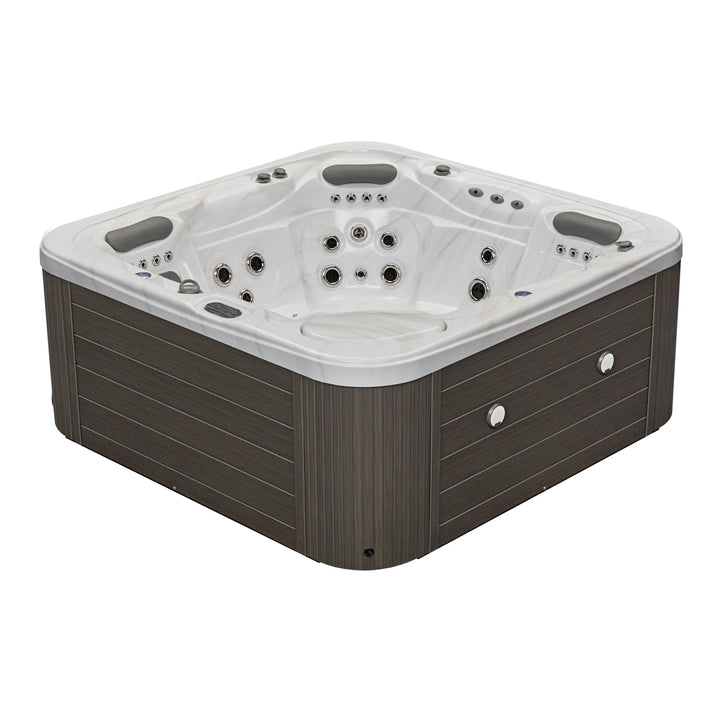 Luxury Spa Infinity Elite Series hot tub with multiple jets and cushioned headrests in dark wood finish