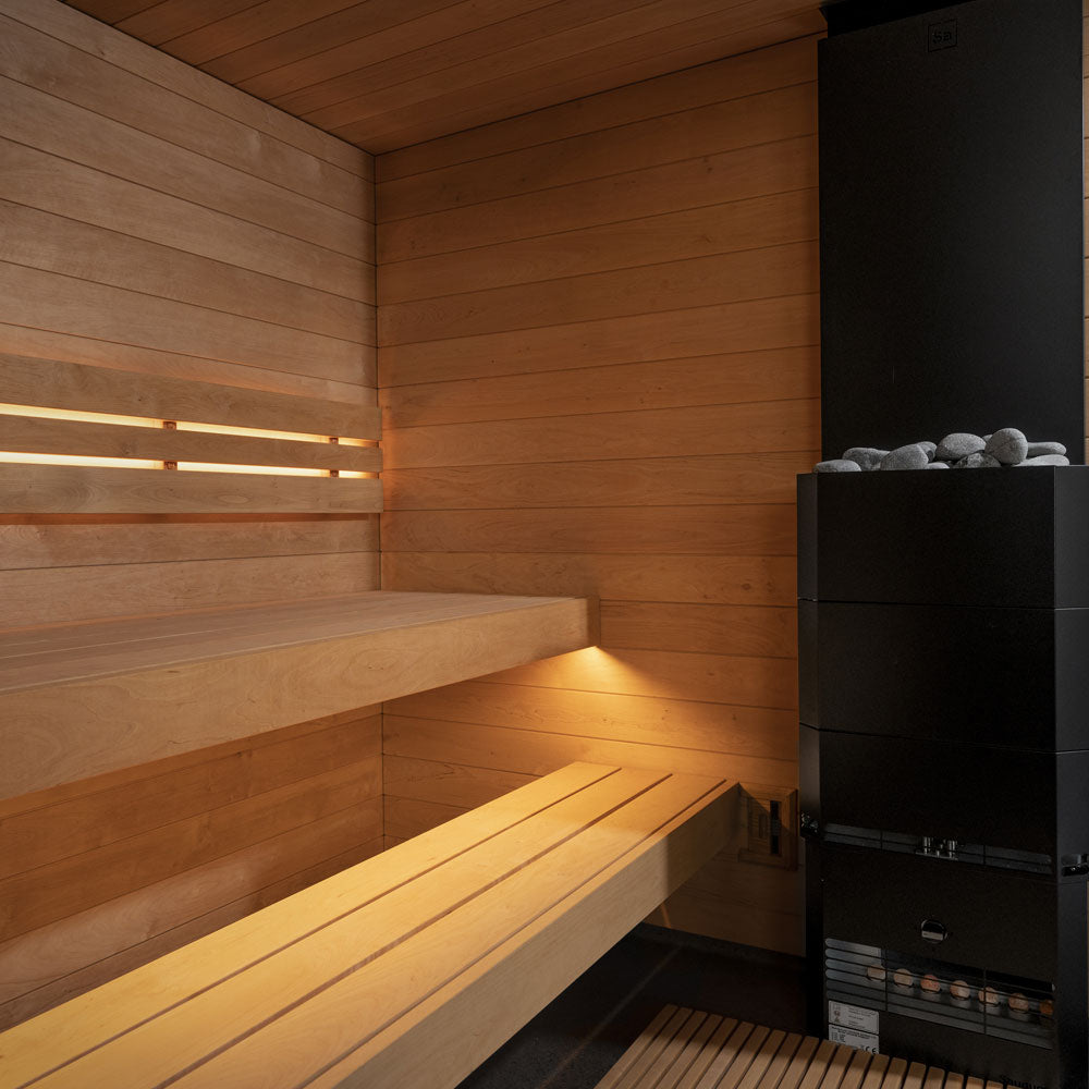Interior view of a luxury backyard sauna with wooden benches and black heater by SaunaLife