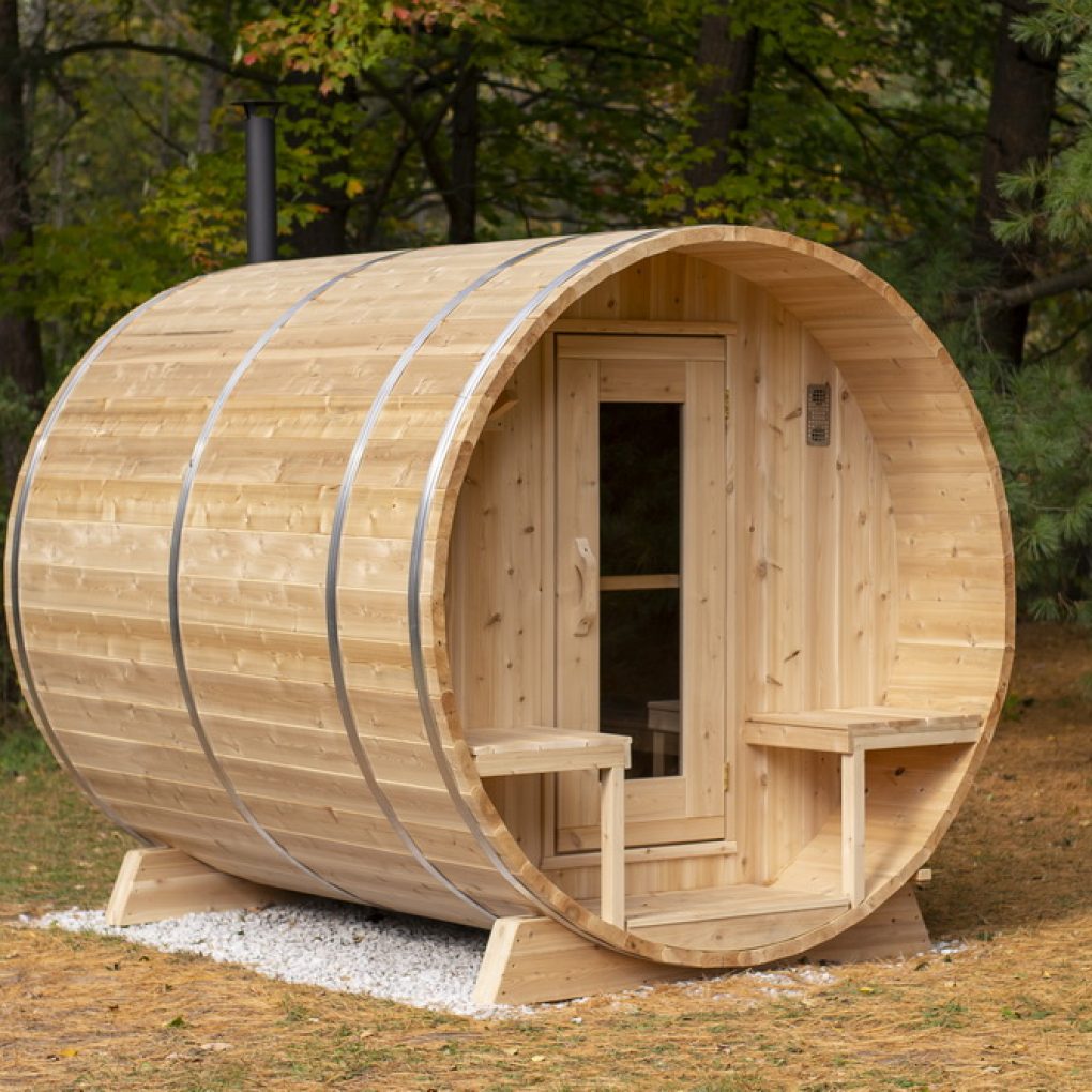 Leisurecraft luxury barrel sauna made of natural wood with a round shape and glass door in outdoor setting