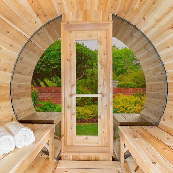 Interior view of Leisurecraft luxury barrel sauna with wooden benches and rolled towels