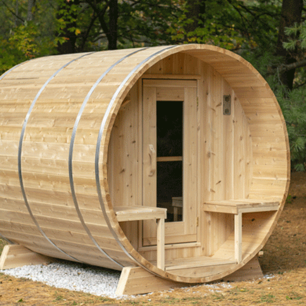 Leisurecraft luxury barrel sauna made of natural wood with a cozy entry and seating outside