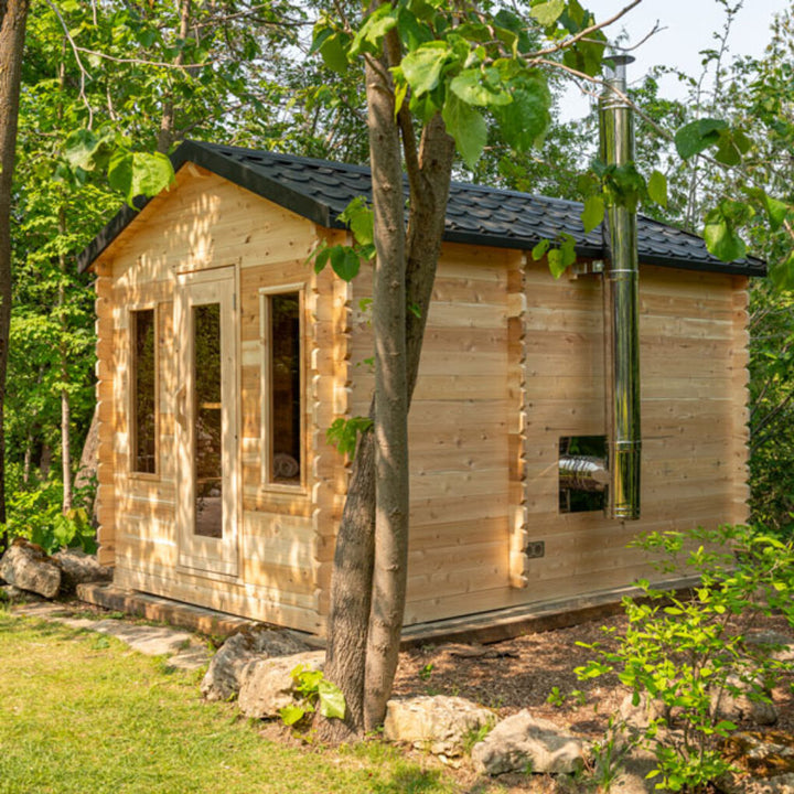 Leisurecraft traditional luxury cabin sauna made of natural wood with black roof in a forest setting