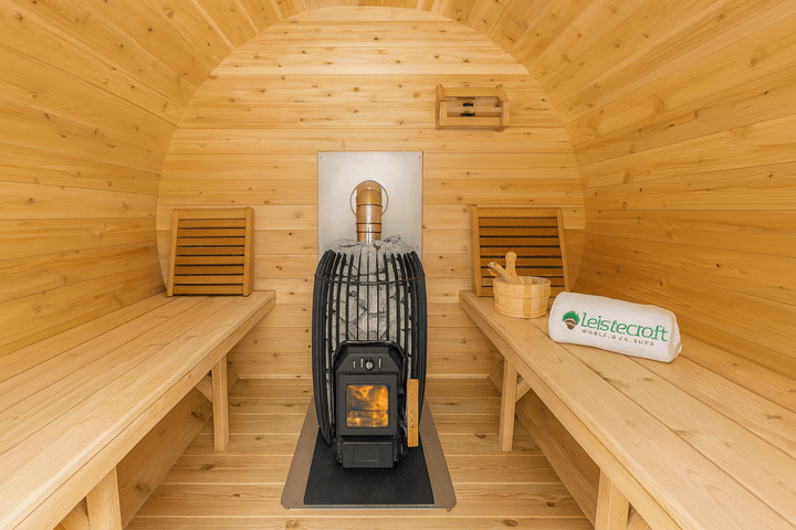 Interior of a Luxury Outdoor Barrel Sauna with wooden benches and a traditional stove