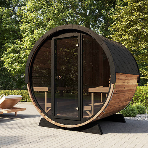 SaunaLife luxury outdoor barrel sauna with glass door and wood benches set on patio surrounded by greenery