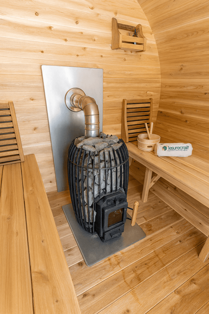 Luxury Outdoor Barrel Sauna interior with a wood-burning stove and wooden benches for relaxation