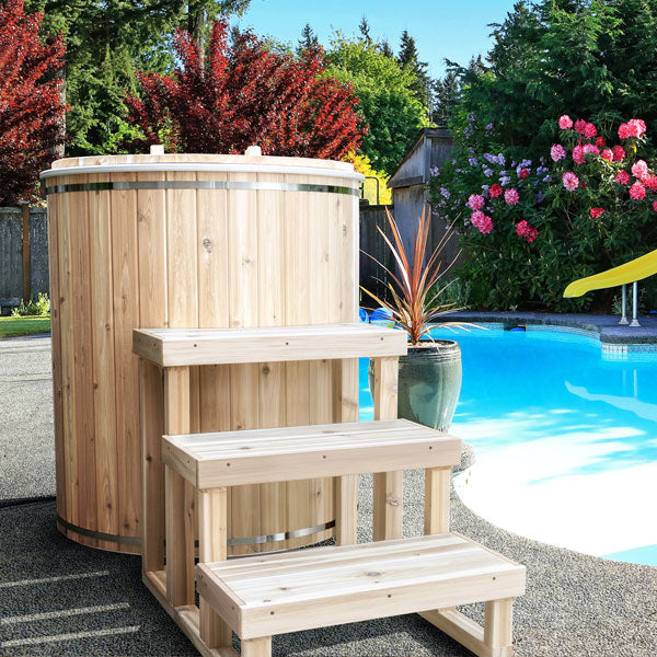 Leisurecraft luxury plunge tubs made of wood with steps near a swimming pool for relaxation