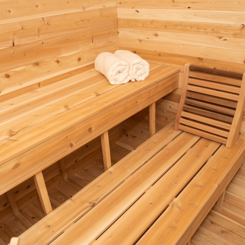 Leisurecraft traditional sauna interior with wooden benches and rolled towels in outdoor luxury sauna
