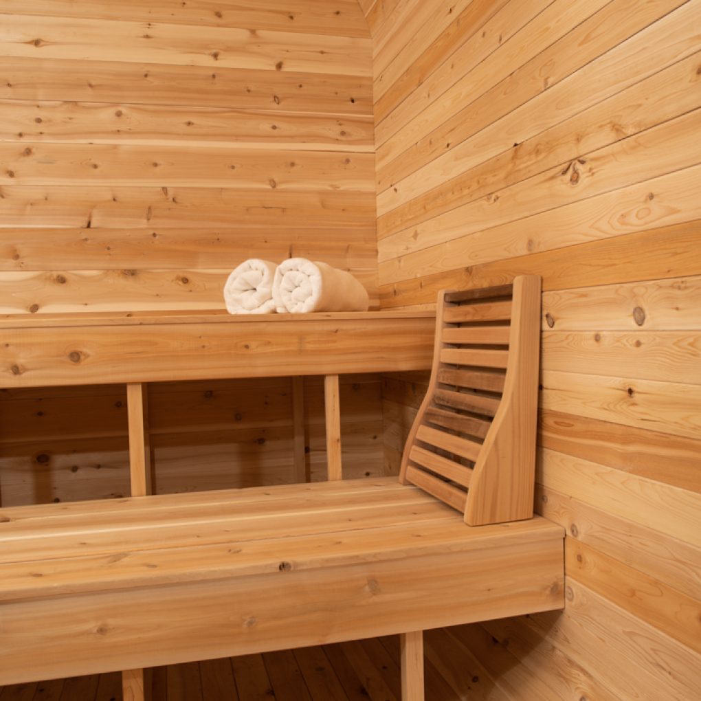 Leisurecraft traditional sauna interior with wooden benches and rolled towels showcasing outdoor luxury sauna design