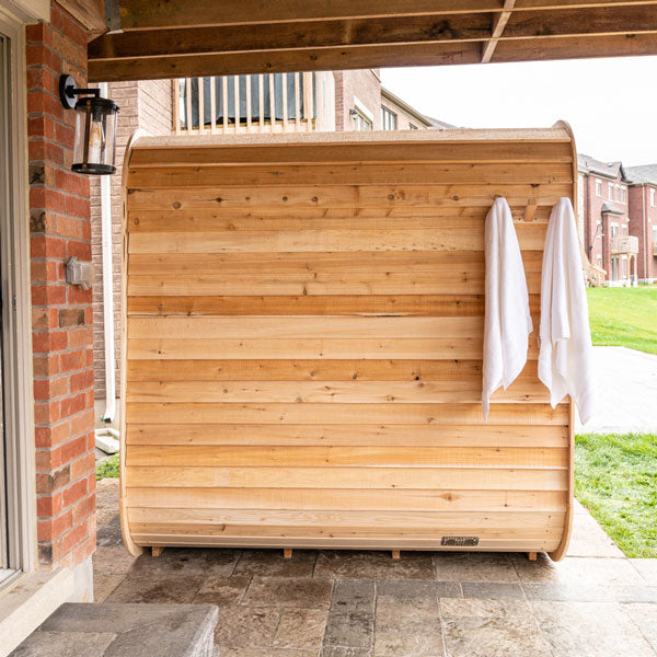 Leisurecraft traditional outdoor luxury sauna made of natural wood with towels hanging outside